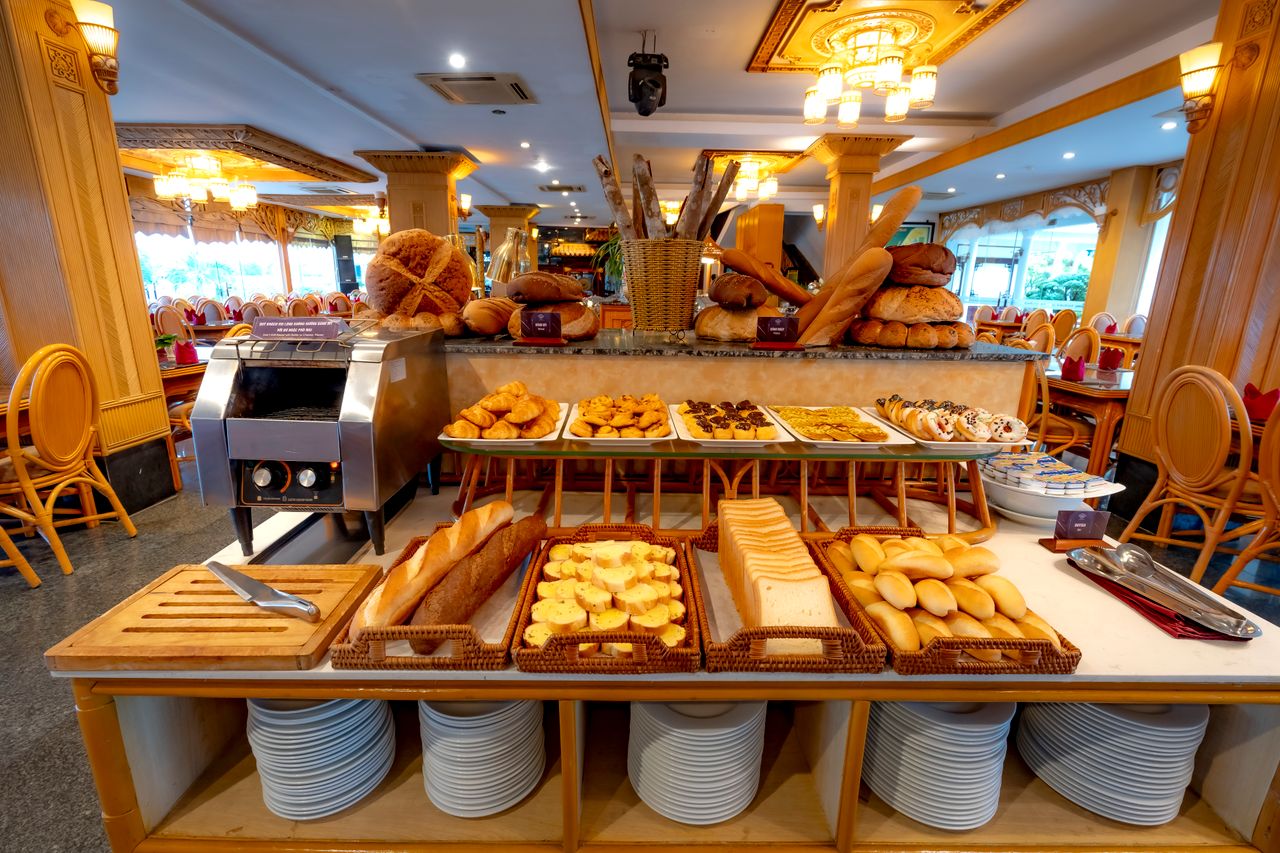 Opulent restaurant interior with a variety of breads and pastries elegantly displayed.