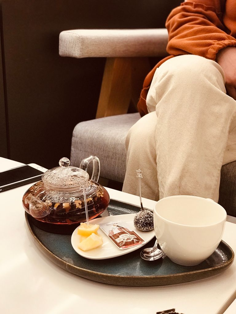 Warm indoor setting with glass teapot, teacup, and snacks on a tray in Van, Turkey.
